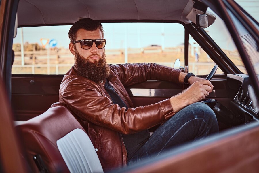 Classic brown leather jacket paired with a white shirt and sunglasses, ideal for versatile travel wear.