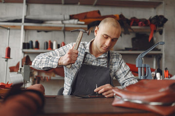 Buffing a leather jacket with a microfiber cloth to condition and maintain its shine.